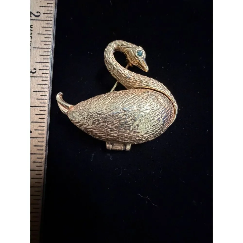 vtg.  Gold toned Swan Brooch/locket with Green Rhinestone eyes and opens up to